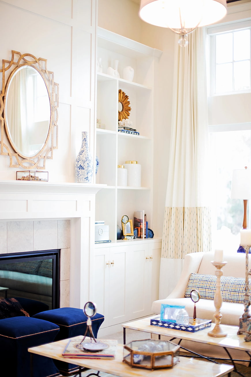 Bright White Living Room with Built-in Shelving and Fireplace