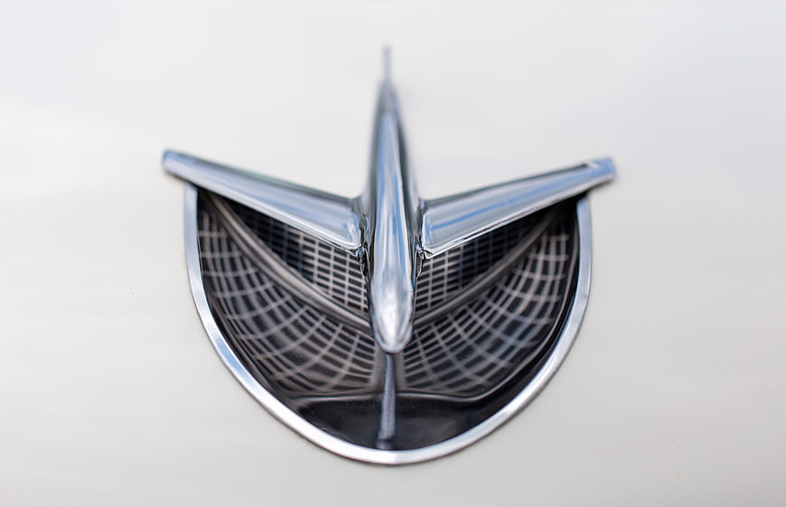Close-up of vintage chrome car hood ornament