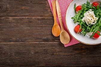 Healthy Arugula Salad with Cherry Tomatoes on Wooden Table