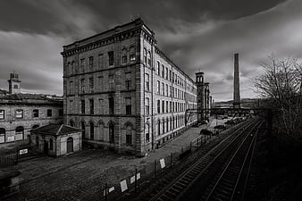 Black and white photo of historic textile mill and railway tracks