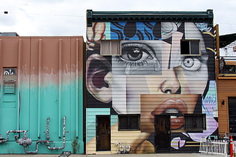Large Street Art Mural of a Woman's Face on Urban Building