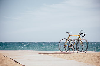 Yellow Bicycle on Wooden Boardwalk by the Ocean